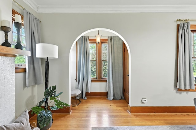 2311 N 51st St, Omaha, NE 68104 - foyer with wood-type flooring, arched walkways, crown molding, and plenty of natural light