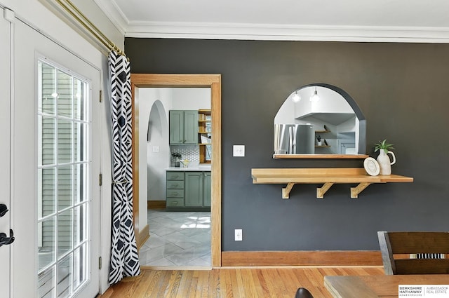 2311 N 51st St, Omaha, NE 68104 - hall featuring crown molding, light wood-style floors, and arched walkways