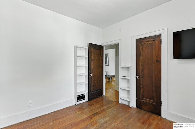 2311 N 51st St, Omaha, NE 68104 - unfurnished bedroom with hardwood / wood-style floors and baseboards