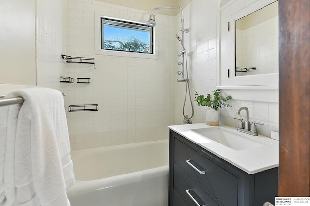 2311 N 51st St, Omaha, NE 68104 - full bath featuring vanity, decorative backsplash, shower / tub combination, and tile walls