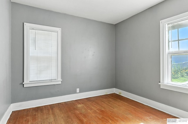 2311 N 51st St, Omaha, NE 68104 - spare room with wood finished floors and healthy amount of natural light