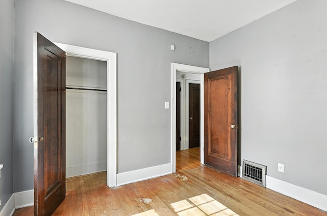 2311 N 51st St, Omaha, NE 68104 - unfurnished bedroom featuring wood finished floors and a closet