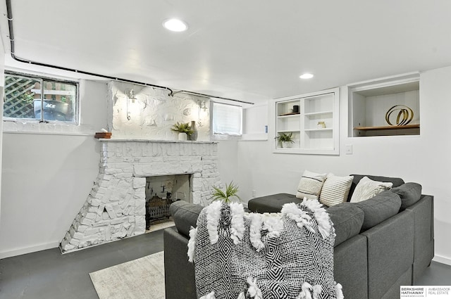 2311 N 51st St, Omaha, NE 68104 - living area featuring concrete floors, a stone fireplace, and recessed lighting