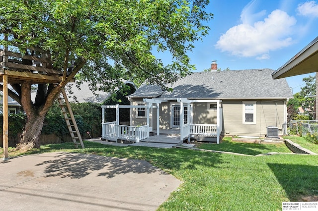 2311 N 51st St, Omaha, NE 68104 - back of property featuring a wooden deck, a chimney, roof with shingles, and a patio area