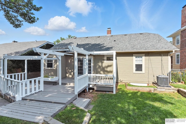 2311 N 51st St, Omaha, NE 68104 - back of house featuring a wooden deck, a lawn, a chimney, and roof with shingles