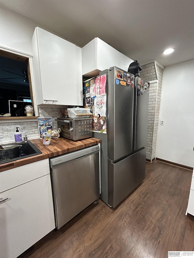 1618 Frederick St, Omaha, NE 68108 - kitchen featuring stainless steel appliances, wooden counters, dark wood-style floors, white cabinets, and backsplash
