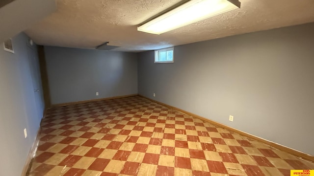 1506 E 1st St, Fremont, NE 68025 - below grade area featuring a textured ceiling, light flooring, and baseboards