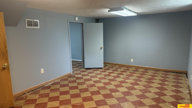 1506 E 1st St, Fremont, NE 68025 - empty room featuring a textured ceiling, light floors, and baseboards