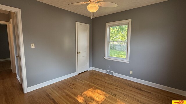 1506 E 1st St, Fremont, NE 68025 - unfurnished room with baseboards, wood finished floors, and ceiling fan