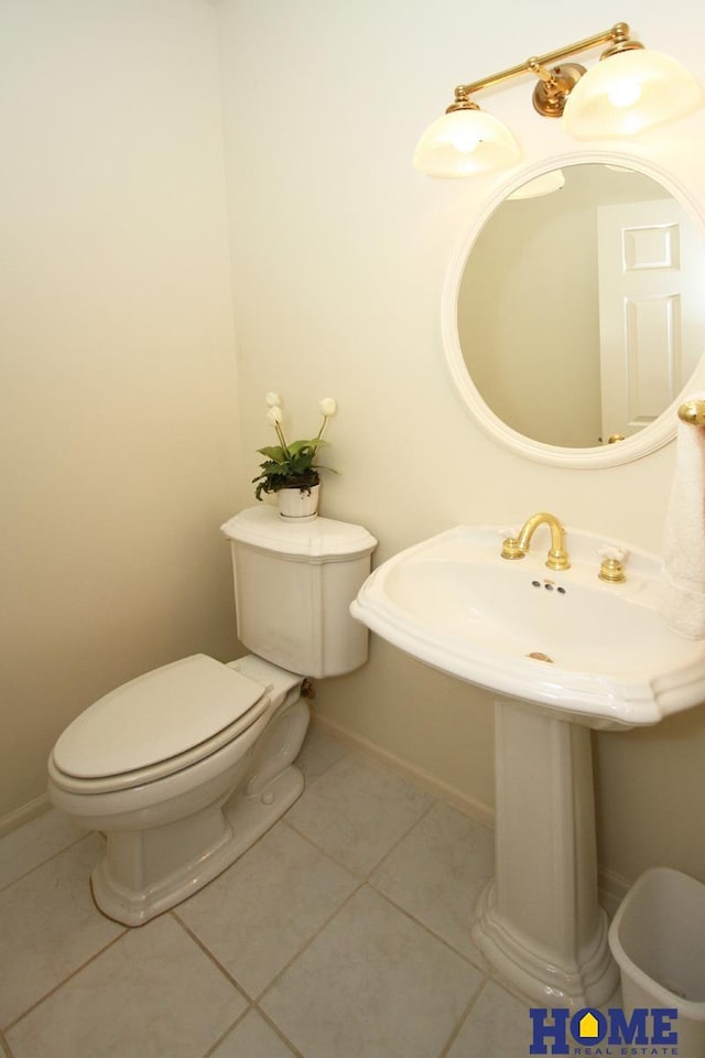 6427 Lone Tree Dr, Lincoln, NE 68512 - bathroom with toilet, tile patterned flooring, a sink, and baseboards