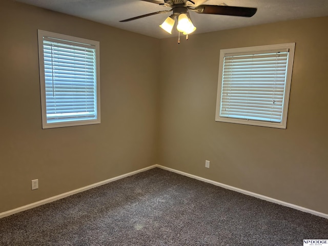 6048 P St, Omaha, NE 68117 - spare room with carpet floors, ceiling fan, and baseboards