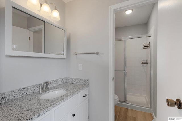 2629 N 129th Cir, Omaha, NE 68164 - full bath with a shower stall, vanity, wood finished floors, and toilet