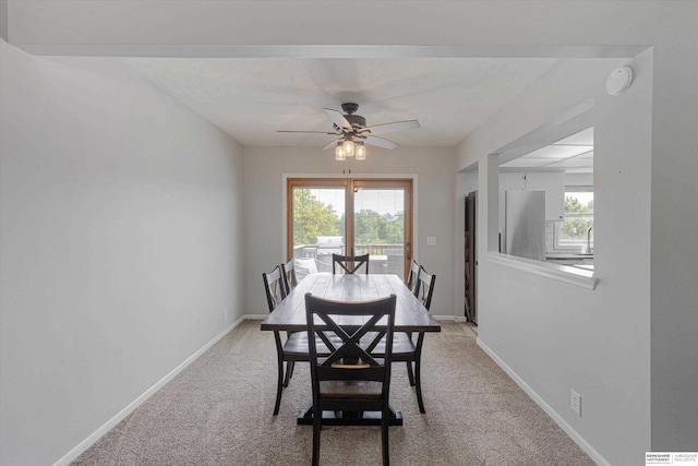 2629 N 129th Cir, Omaha, NE 68164 - dining room with ceiling fan, light colored carpet, and baseboards