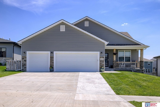 1637 W Avalanche Rd, Lincoln, NE 68521 - view of front of home with driveway, an attached garage, a porch, a front lawn, and stone siding