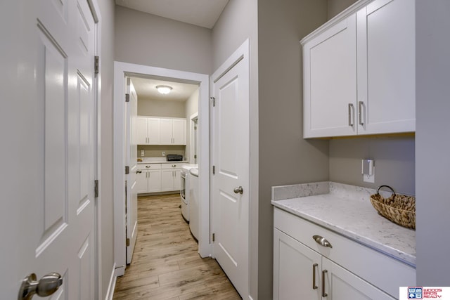 1637 W Avalanche Rd, Lincoln, NE 68521 - laundry area featuring cabinet space, independent washer and dryer, and light wood-style flooring