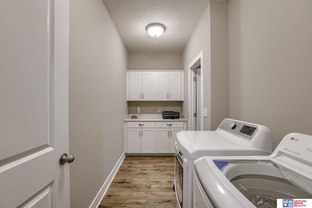1637 W Avalanche Rd, Lincoln, NE 68521 - laundry room featuring independent washer and dryer, light wood finished floors, a textured ceiling, and cabinet space