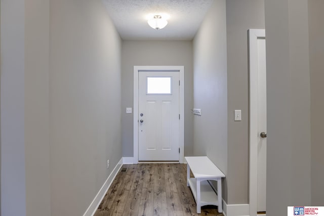 1637 W Avalanche Rd, Lincoln, NE 68521 - doorway featuring light wood-style flooring and a textured ceiling