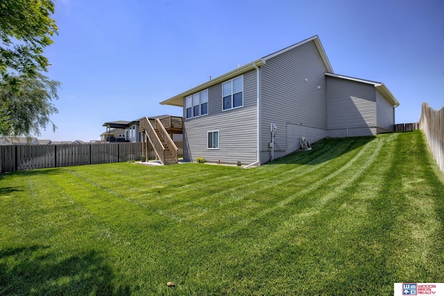 1637 W Avalanche Rd, Lincoln, NE 68521 - back of property with stairway, a fenced backyard, and a wooden deck