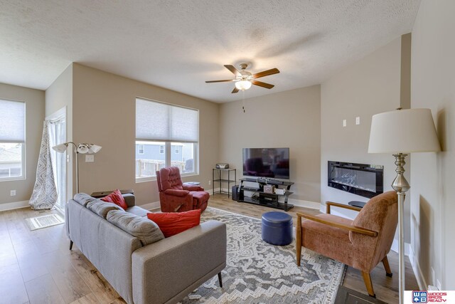 1637 W Avalanche Rd, Lincoln, NE 68521 - living room featuring wood finished floors, a ceiling fan, and a textured ceiling