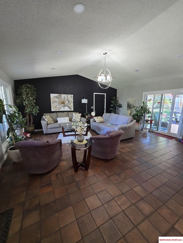 1807 S 16th Circle Dr, Beatrice, NE 68310 - living room featuring plenty of natural light, a textured ceiling, vaulted ceiling, and a chandelier