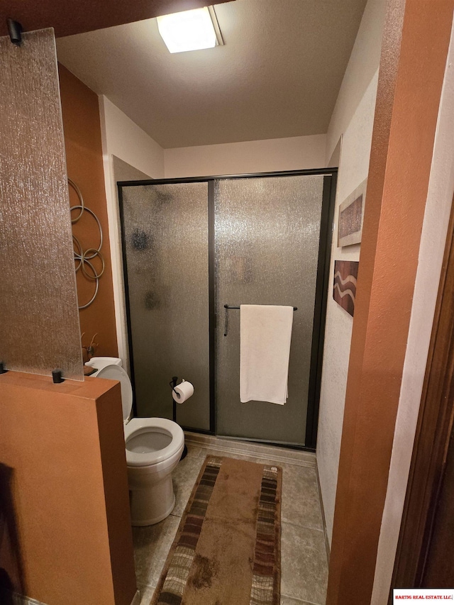 1807 S 16th Circle Dr, Beatrice, NE 68310 - bathroom with toilet, a shower stall, and tile patterned flooring
