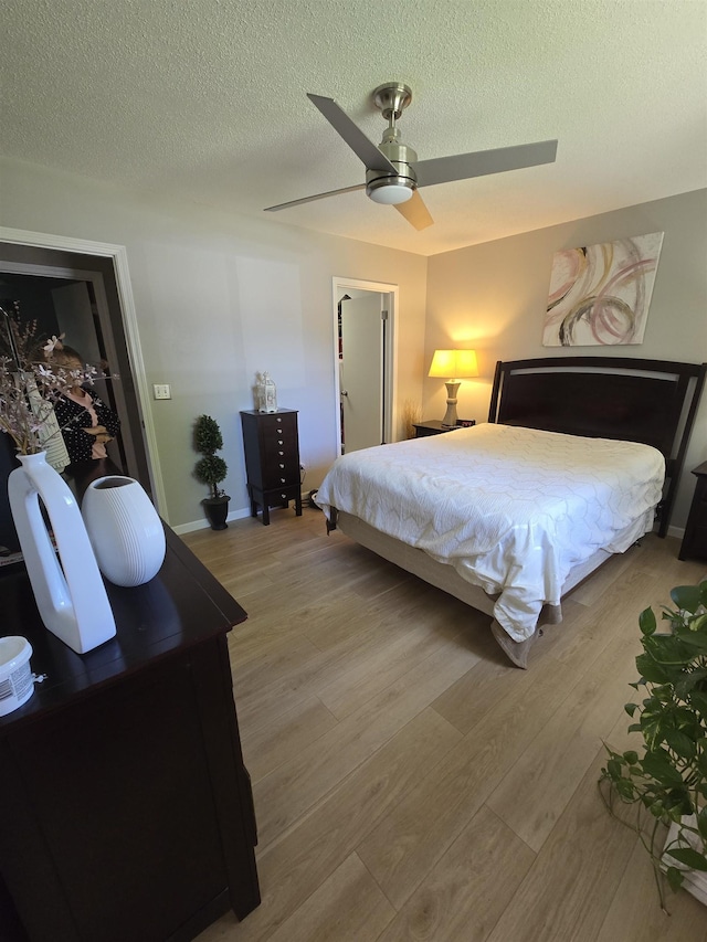 1807 S 16th Circle Dr, Beatrice, NE 68310 - bedroom featuring light wood finished floors, a textured ceiling, and a ceiling fan