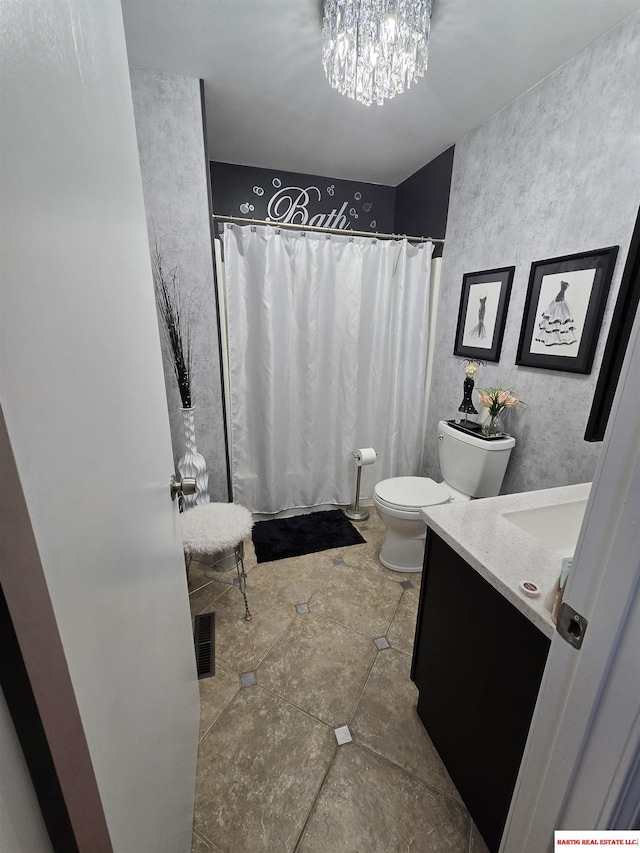 1807 S 16th Circle Dr, Beatrice, NE 68310 - bathroom with vanity, toilet, a chandelier, and a shower with curtain
