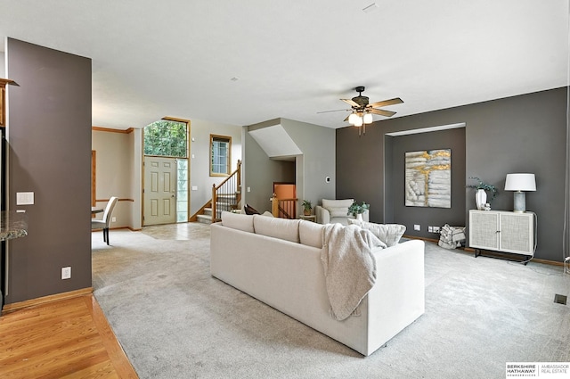 5418 S 165th St, Omaha, NE 68135 - living room with stairway, a ceiling fan, light wood-style floors, and light carpet