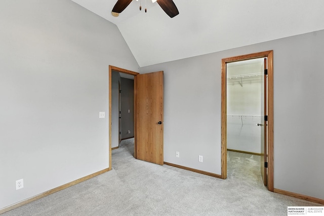 5418 S 165th St, Omaha, NE 68135 - unfurnished bedroom featuring a walk in closet, vaulted ceiling, carpet flooring, a closet, and a ceiling fan