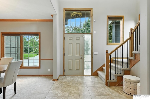 5418 S 165th St, Omaha, NE 68135 - foyer entrance with stairway, ornamental molding, and carpet
