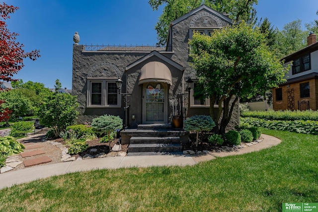 523 N 52nd St, Omaha, NE 68132 - view of front facade featuring stone siding, stucco siding, and a front yard