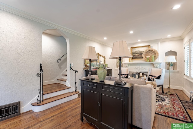 523 N 52nd St, Omaha, NE 68132 - living area featuring crown molding, a textured wall, wood finished floors, stairway, and recessed lighting