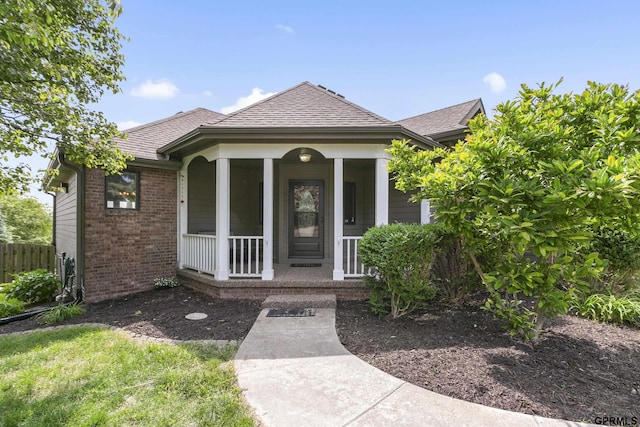 759 Simms Ave, Council Bluffs, IA 51503 - entrance to property with covered porch, brick siding, and a shingled roof