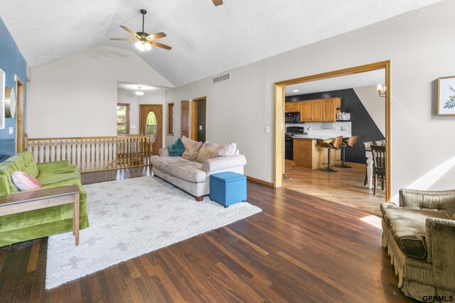 759 Simms Ave, Council Bluffs, IA 51503 - living room with a ceiling fan, vaulted ceiling, wood finished floors, and baseboards