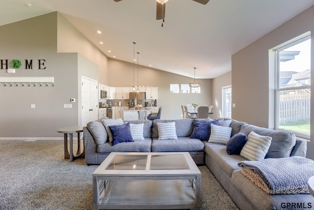 7810 S 184th Ave, Omaha, NE 68136 - carpeted living room with a ceiling fan, recessed lighting, baseboards, and high vaulted ceiling