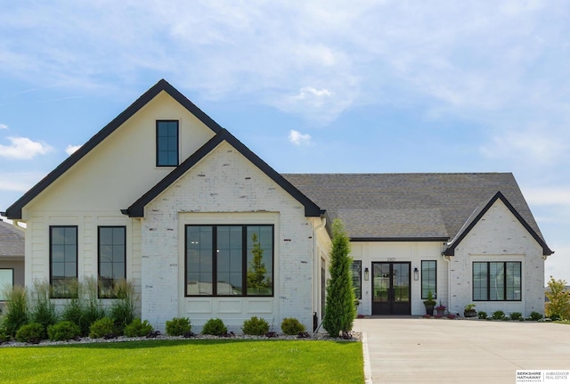 3307 S 209th St, Omaha, NE 68022 - view of front of house featuring french doors, a front lawn, roof with shingles, and brick siding