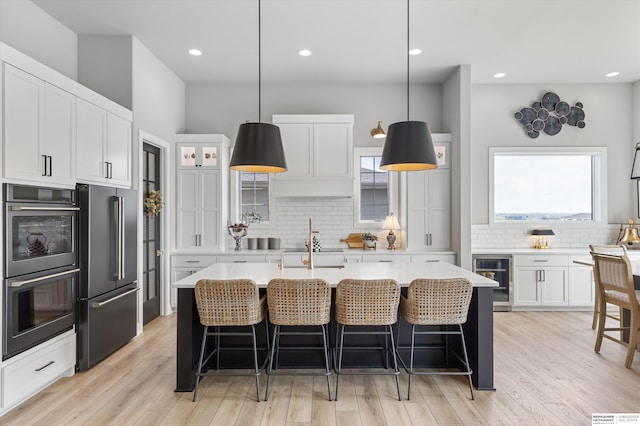 3307 S 209th St, Omaha, NE 68022 - kitchen featuring high quality fridge, beverage cooler, multiple ovens, backsplash, and recessed lighting