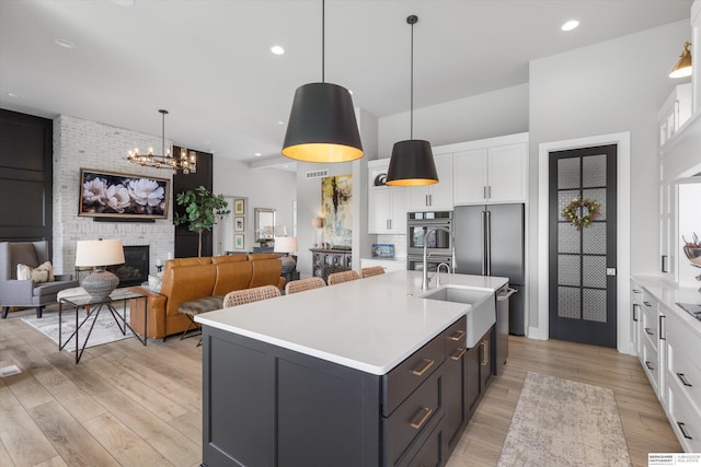 3307 S 209th St, Omaha, NE 68022 - kitchen featuring white cabinetry, light countertops, light wood finished floors, appliances with stainless steel finishes, and recessed lighting