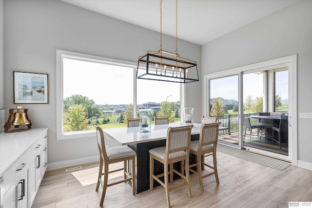 3307 S 209th St, Omaha, NE 68022 - dining room featuring light wood-style flooring and a chandelier