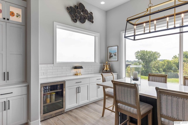 3307 S 209th St, Omaha, NE 68022 - dining area with beverage cooler, light wood-type flooring, and recessed lighting