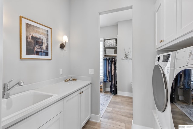 3307 S 209th St, Omaha, NE 68022 - laundry area featuring cabinet space, washer / clothes dryer, and light wood finished floors