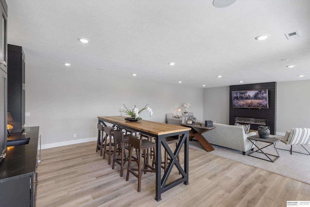 3307 S 209th St, Omaha, NE 68022 - dining area featuring light wood-style flooring, recessed lighting, and a fireplace