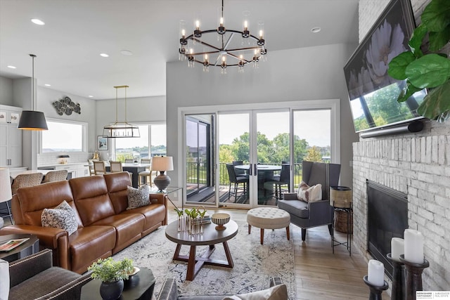 3307 S 209th St, Omaha, NE 68022 - living area featuring wood finished floors, a chandelier, recessed lighting, and a brick fireplace