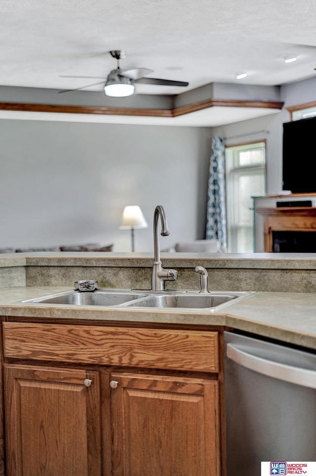 1035 Primrose Ln, Hickman, NE 68372 - kitchen featuring stainless steel dishwasher, a sink, brown cabinets, and ceiling fan