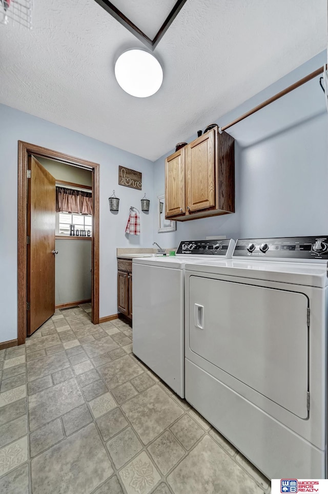 1035 Primrose Ln, Hickman, NE 68372 - laundry area with cabinet space, separate washer and dryer, baseboards, and a textured ceiling