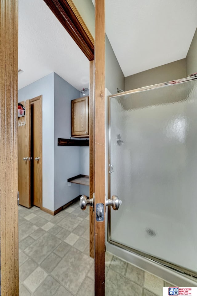 1035 Primrose Ln, Hickman, NE 68372 - bathroom with a stall shower and baseboards