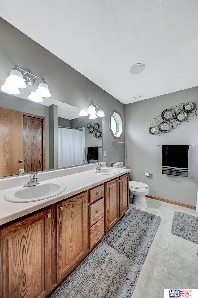 1035 Primrose Ln, Hickman, NE 68372 - full bath featuring double vanity, toilet, tile patterned floors, and a shower with shower curtain
