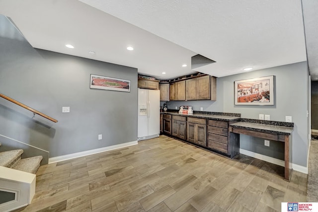 1035 Primrose Ln, Hickman, NE 68372 - kitchen with white fridge with ice dispenser, dark countertops, light wood finished floors, baseboards, and recessed lighting