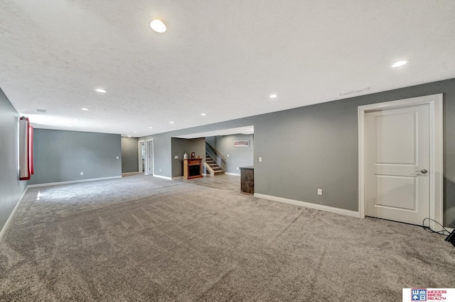 1035 Primrose Ln, Hickman, NE 68372 - finished basement with carpet floors, stairway, baseboards, and recessed lighting