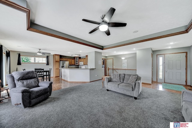1035 Primrose Ln, Hickman, NE 68372 - living room featuring a ceiling fan, light carpet, recessed lighting, a tray ceiling, and baseboards